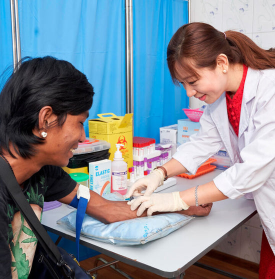27.09.2019, Yangon, Myanmar Mr Thura Aung, a beneficiary of the hepatitis C community testing and treatment (CT2) study, provides a blood sample to May Yu Yu Win, lab technician at the Burnet Institute Drop-in clinic, one of FIND’s HEAD-Start project sites in Yangon. Photo credits: FIND / Kyaw Win Hlaing